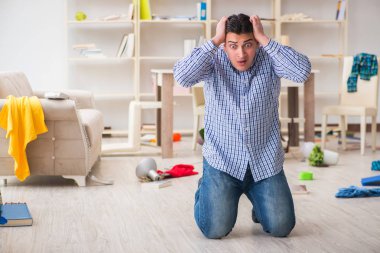 Hırsızlar tarafından soyulduktan sonra evini bulan bir adam.