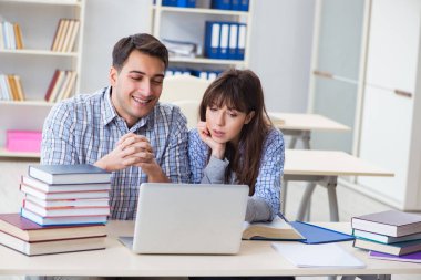 Sınıfta oturan ve okuyan öğrenciler