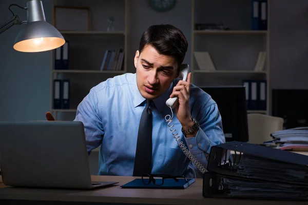 Mitarbeiter arbeitet spät in der Nacht bei wichtigem Bericht — Stockfoto