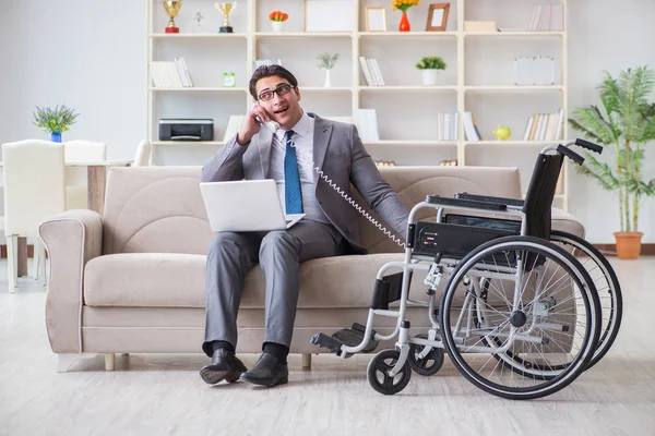 Dsabled businessman on wheelchair working home