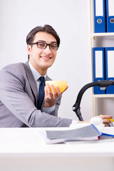 Empresario cuidando al bebé recién nacido en la oficina — Foto de Stock