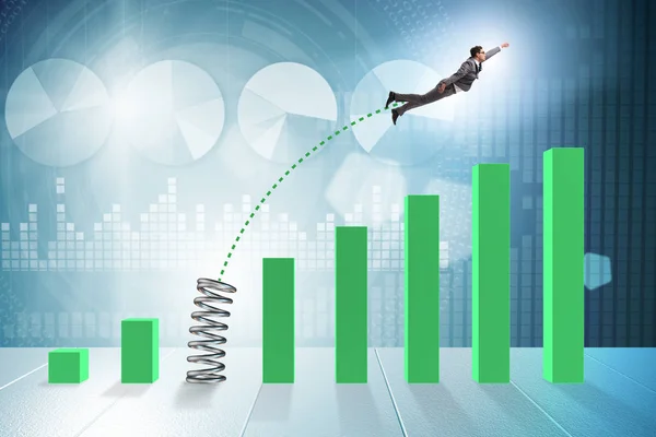 Business people jumping over bar charts — Stock Photo, Image