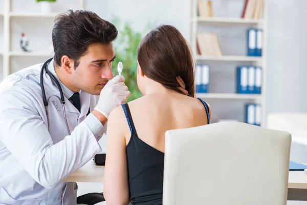 Doctor checking patients ear during medical examination — Stock Photo, Image