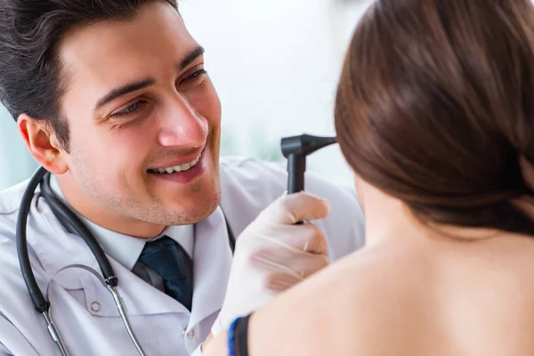 Doctor checking patients ear during medical examination