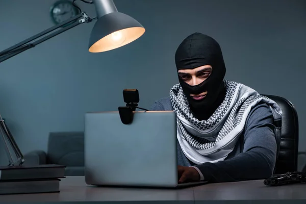 Hacker wearing balaclava mask hacking computer — Stock Photo, Image