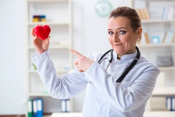 Cardiologist with red heart in medical concept — Stock Photo, Image