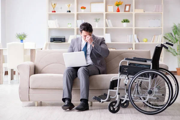 Dsabled businessman on wheelchair working home