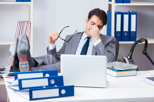 Businessman looking after newborn baby in office — Stock Photo, Image