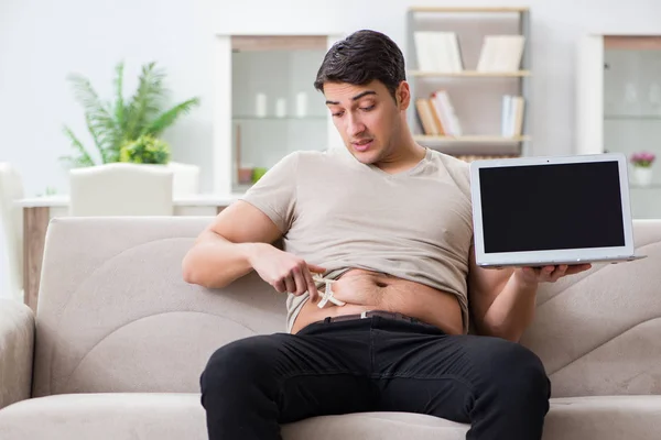 Man measuring body fat with calipers — Stock Photo, Image