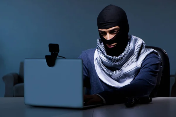 Hacker wearing balaclava mask hacking computer — Stock Photo, Image