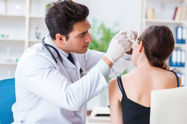 Doctor checking patients ear during medical examination