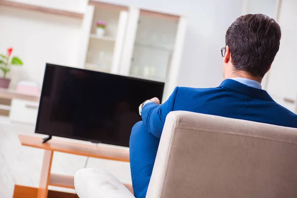 Businesman watching tv in office — Stock Photo, Image