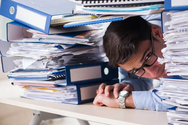 Extremely busy businessman working in office