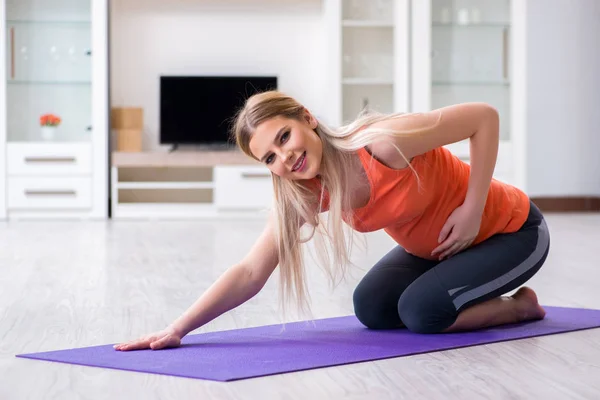 Mujer embarazada haciendo ejercicio deportivo en casa — Foto de Stock