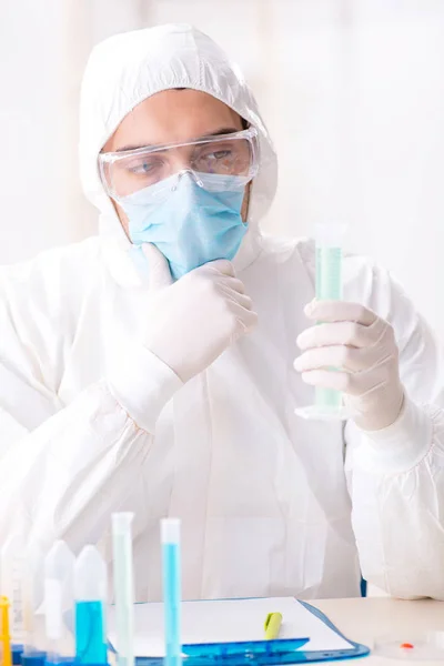 Jovem estudante de química que trabalha em laboratório em produtos químicos — Fotografia de Stock