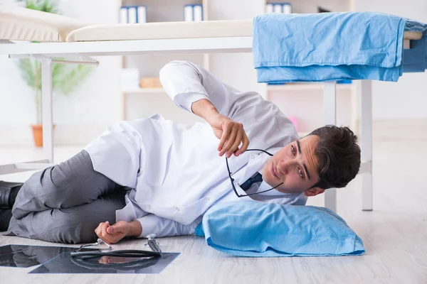 Doctor sleeping on floor after long night shift