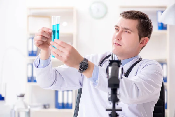 Male doctor looking at lab results in hospital