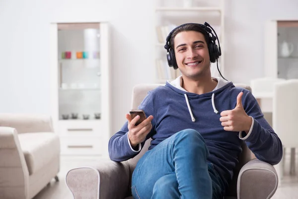 Joven hombre guapo escuchando música con auriculares —  Fotos de Stock