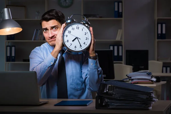 Young employee working overtime to meet deadline