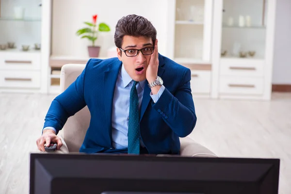 Businesman watching tv in office