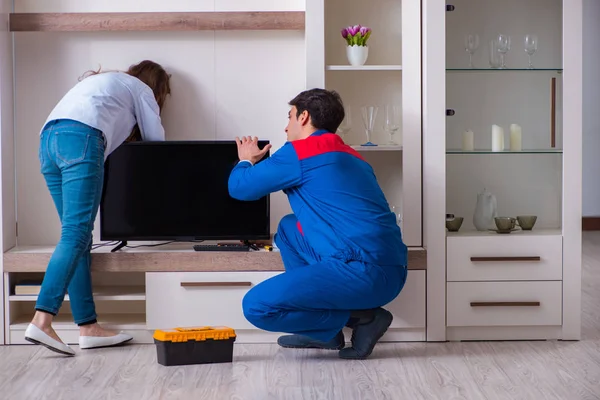 Repairman repairing tv at home