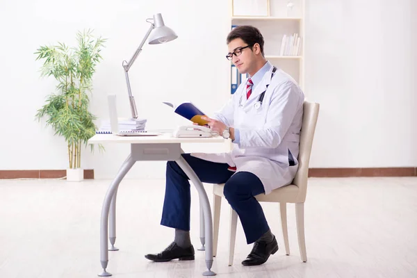 Young handsome doctor working in hospital room — Stock Photo, Image