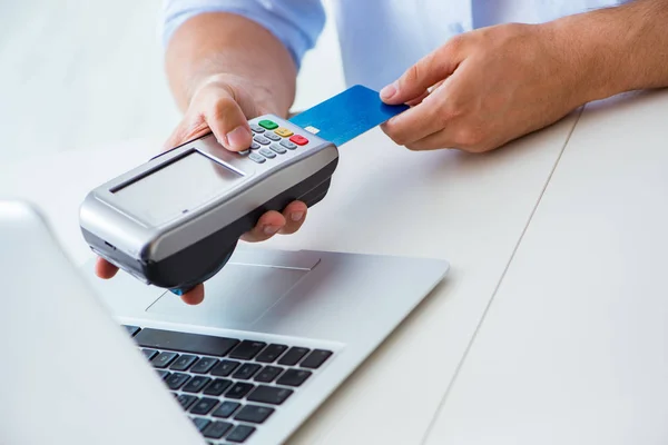 Man processing credit card transaction with POS terminal