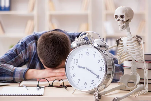 Student and skeleton preparing for school exams — Stock Photo, Image