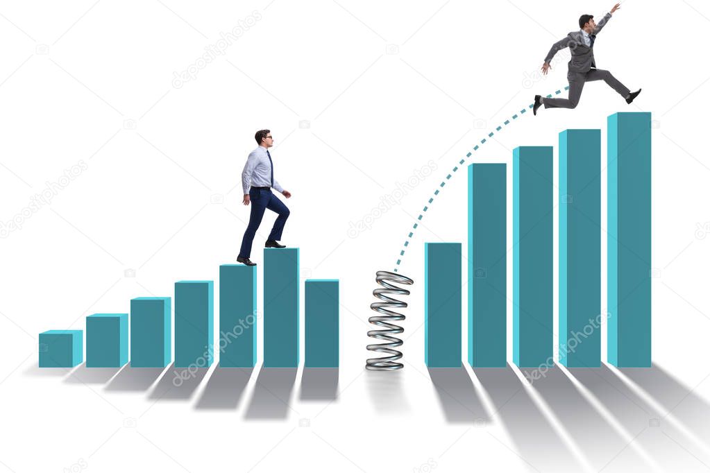 Business people jumping over bar charts