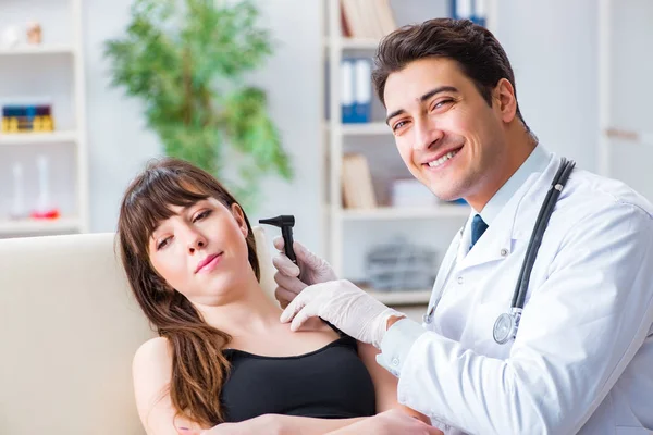 Doctor checking patients ear during medical examination