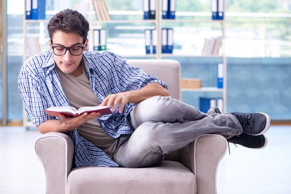 Estudiante leyendo libros y preparándose para los exámenes en la biblioteca — Foto de Stock