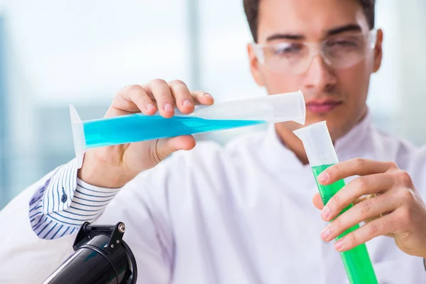 Joven estudiante de química trabajando en laboratorio sobre productos químicos — Foto de Stock