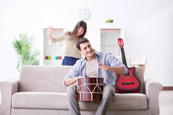 Joven familia cantando y tocando música en casa — Foto de Stock