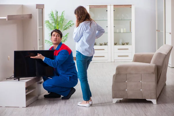 Repairman repairing tv at home