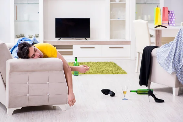 Man with mess at home after house party