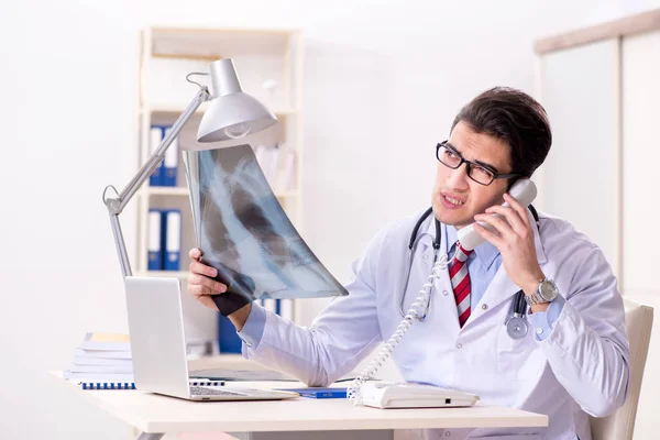 Young handsome doctor working in hospital room — Stock Photo, Image
