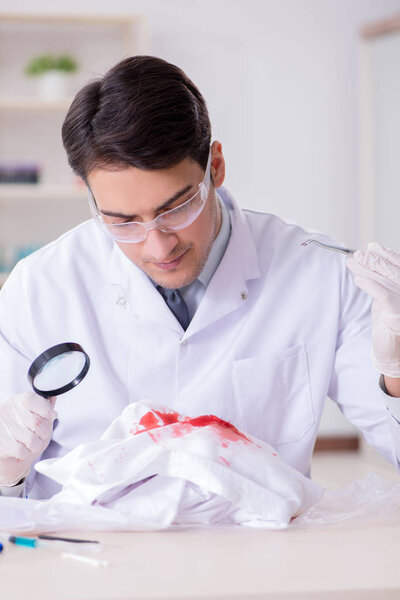 Expert criminologist working in the lab for evidence