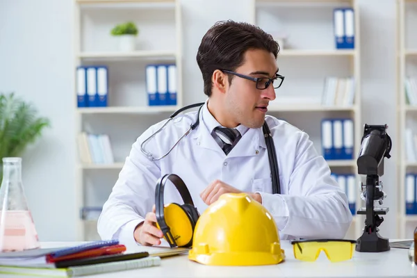 stock image Safety doctor advising about noise cancelling headphones