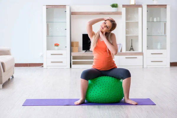 Jonge vrouw bereidt zich voor op de geboorte oefening thuis — Stockfoto