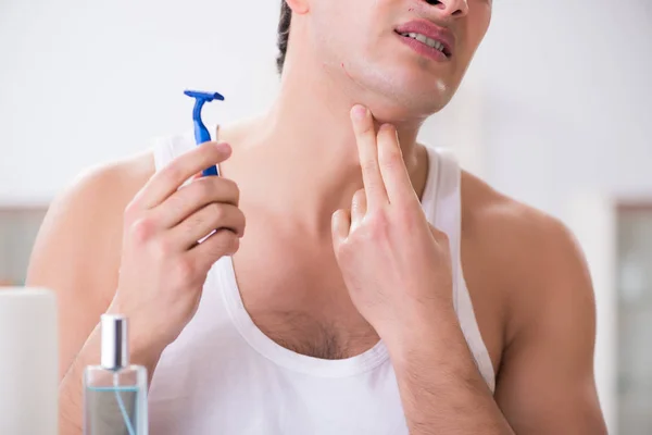 Young handsome man shaving early in the morning at home — Stock Photo, Image