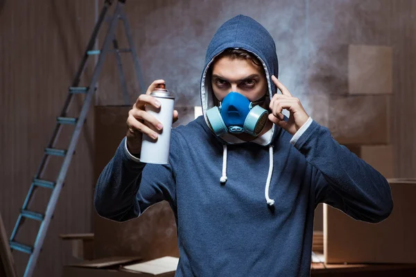 Graffiti painter in dark smokey room — Stock Photo, Image