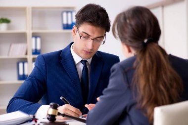 Lawyer talking to his client in office clipart