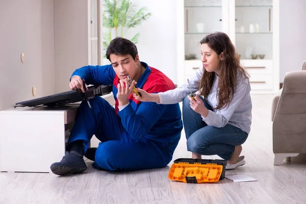 Tv repairman technician repairing tv at home