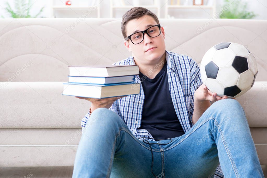 Young student trying to balance studying and playing football
