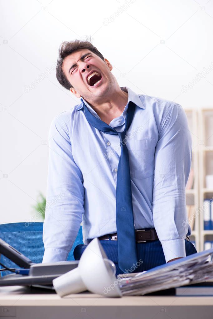 Angry businessman frustrated with too much work