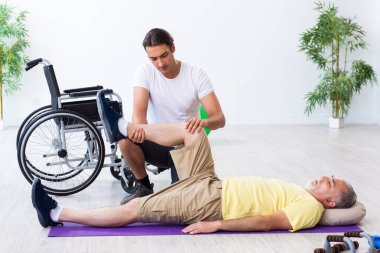 Yaşlı adam içeride egzersiz yapıyor.