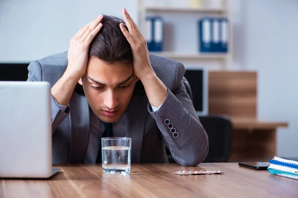 Sick male employee suffering in the office — Stock Photo, Image