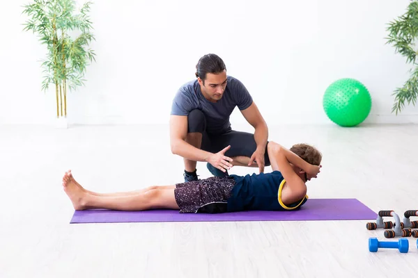 Young father and his son doing exercises — Stock Photo, Image