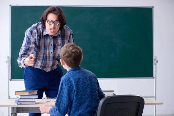 Funny male teacher and boy in the classroom