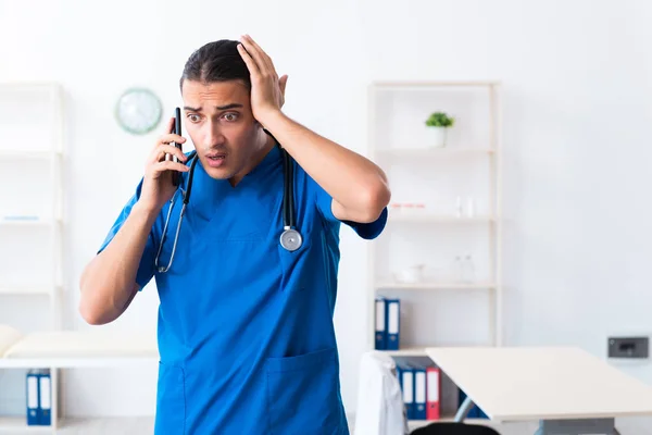 Young male doctor working in the clinic — Stock Photo, Image